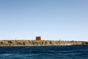 Mediterranean sea and in the horizon Tabarca island. Clear sky. Alicante, Spain. Text of text.