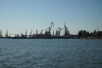 View from afar on cranes and ships in the port of Berdyansk
