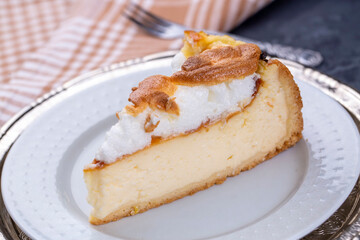 Homemade german cheesecake on beautiful plate on white table.
