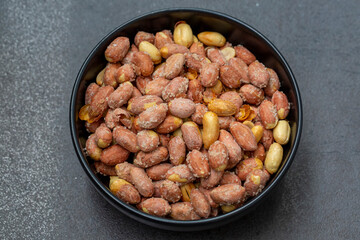 Salted peanuts in a glass bowl