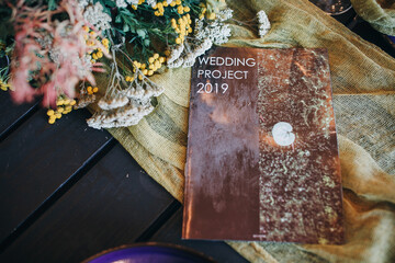 Catalog on a table decorated with flowers