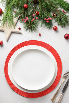 Christmas Festive Table Setting With White And Red Holiday Elegant Decorations On White. View From Above. Vertical.