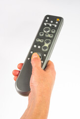 hand holding a remote control on white background, close-up