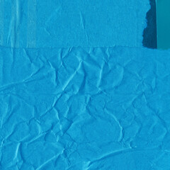 Blue torn paper collage close-up. Texture made from various paper and cardboard parts. Damaged old paper background. Vintage blank wallpaper. Material design backdrop.