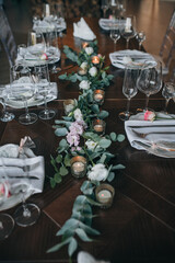 Candles and natural flowers in the decoration of the banquet table