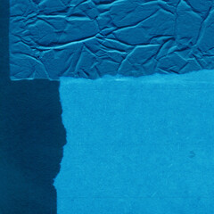 Blue torn paper collage close-up. Texture made from various paper and cardboard parts. Damaged old paper background. Vintage blank wallpaper. Material design backdrop.