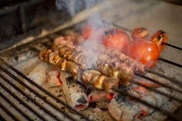 Traditional Turkish Adana Kebab or Kebap on the grill with skewers in the turkish restaurant for dinner. Turkish cuisine food culture in Turkey.