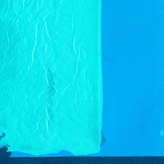 Blue torn paper collage close-up. Texture made from various paper and cardboard parts. Damaged old paper background. Vintage blank wallpaper. Material design backdrop.