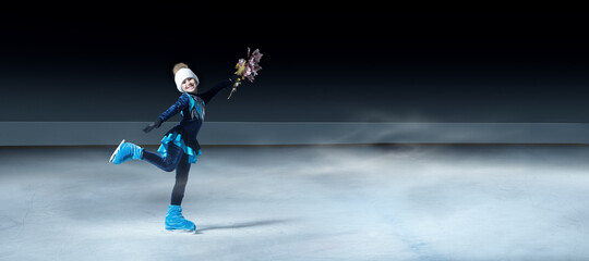 view of child figure skater on dark ice arena background