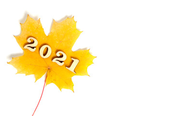 Yellow maple leaf with numbers two thousand and twenty-one year,on a white background.