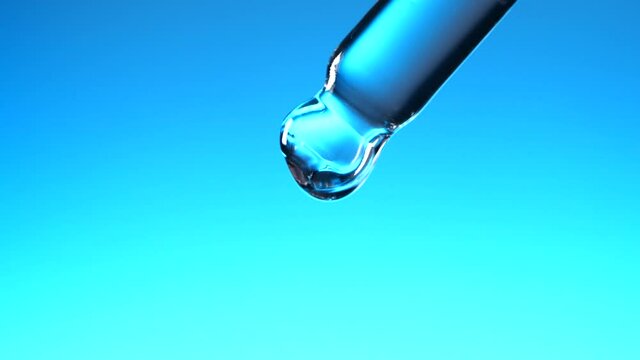 Water dropper in slow motion on blue background