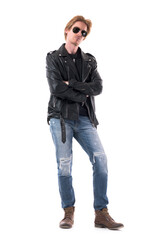 Serious confident stylish man in rocker or biker clothes looking at camera with crossed hands. Full body isolated on white background.