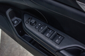 Obraz premium Car arm rest with Control Panel. Door Lock & Mirror Control. window adjustment buttons, door lock. Photography of a modern car.