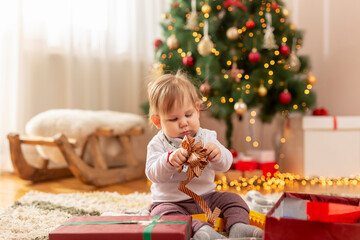 Fototapeta na wymiar Baby boy opening Christmas presents