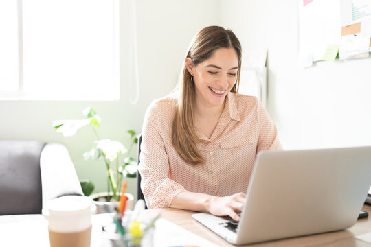 Businesswoman looking happy using a laptop