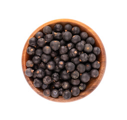 Dry juniper berries in wooden bowl, isolated on white background. Top view.
