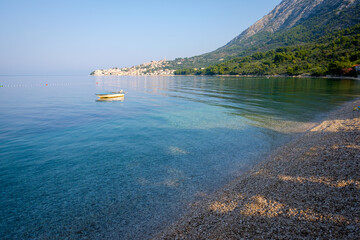 small boat on the sea, empty beach, zivogosce, croatia