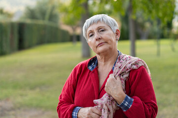 
Smiling older Caucasian woman in red dress and scarf