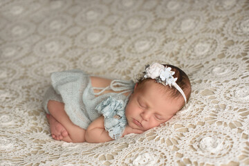 Adorable sleeping newborn girl gently sleeping on a white milk background