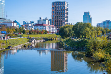 urban landscape in autumn. river, houses, dam. Ekaterinburg
