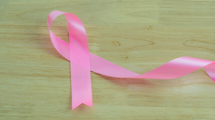 Pink ribbons on wooden background , Breast cancer awareness, abdominal cancer awareness , world cancer day