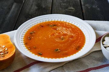 Homemade pumpkin soup on a black table