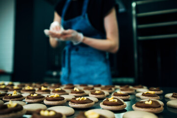 pastru chef making macarons with peanut inside