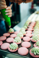 onfectioner making macaroons in pastry shop