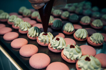 onfectioner making macaroons in pastry shop