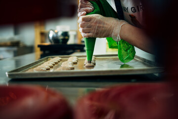 onfectioner making macaroons in pastry shop