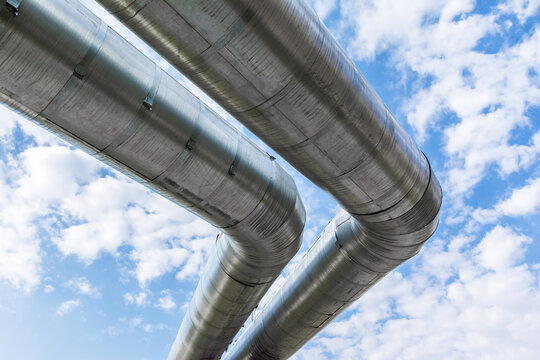heating pipes in isolation against a blue sky with clouds