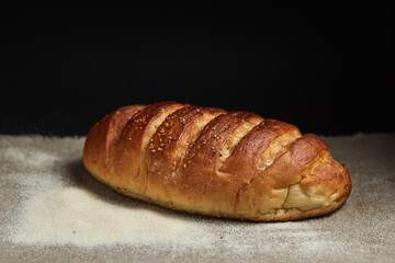 Bread loaf on a coarse gray cloth sprinkled with flour