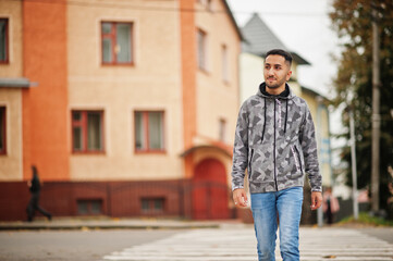 Student kuwaiti man wear at hoodie, walking crosswalk.