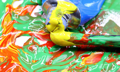 close-up colorful paint splashes with brush background