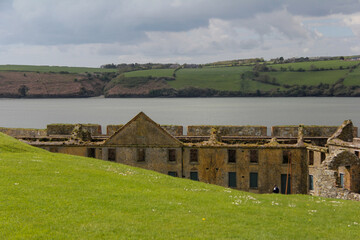 Half demolished building with river and background vegetation in Kinsale
