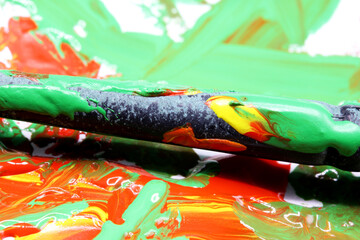 close-up colorful paint splashes with brush background
