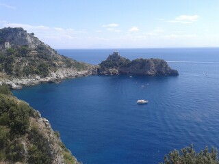 View of Italy's bay during a nice day with some boats on the bay crossing the sea.