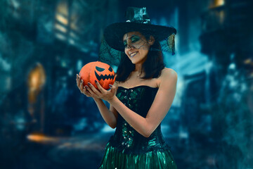 Young witch with pumpkin to halloween