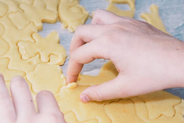 Girl bakes Christmas cookies, cooking in the kitchen.