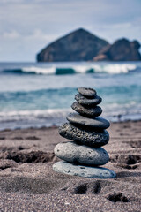 zen stone tower at the Atlantic in Mosteiros Sao Miguel Azores, vertical color photo