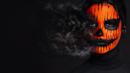 Portrait boy face art painted for halloween dark skull makeup. Dead face make up portrait of young...
