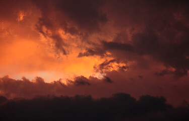 Fototapeta na wymiar Cloudscape. Dramatic sunset sky and clouds with beautiful red, black, yellow and orange colors.