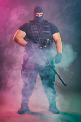 Soldier comes out of the smoke on the battlefield. The concept of military special operations....