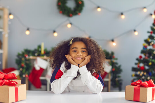 Happy Girl Sitting At Table With Presents During Video Call Or While Recording Christmas Vlog