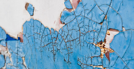 wall texture with cracked peeling blue paint
