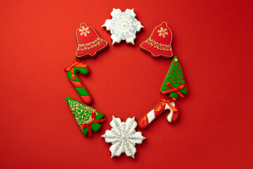 Gingerbread cookies for Christmas celebration on red background