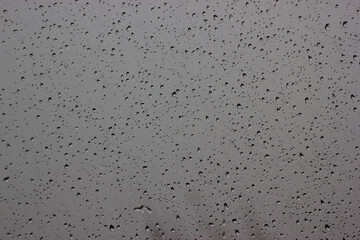 Raindrops on glass on a cloudy autumn day