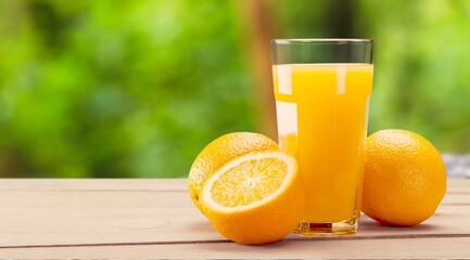 Orange juice and slices of orange on desk