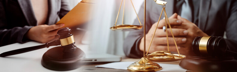Justice and law concept.Male judge in a courtroom with the gavel, working with, computer and...