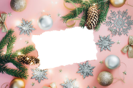 Blank Christmas or New year greeting paper card with fir branches and golden and silver decor. Flat lay. Copy space. Top vew.